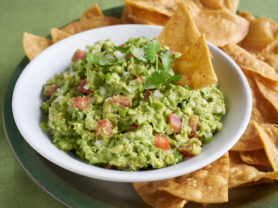 bowl of guacamole and chips